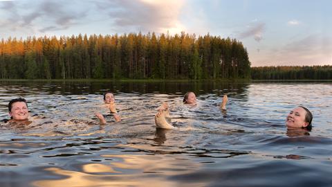Festivalbesucherinnen und -musikerinnen entspannen sich nach der Sauna im See Ontojärvi