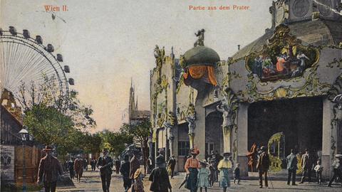 Munteres Treiben unterm Riesenrad: Der Wiener Prater auf einer alten kolorierten Postkarte von 1905